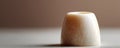 Elegant ivorycolored object on a neutral surface. Soft lighting highlights texture. Ideal for concepts like purity, minimalism, Royalty Free Stock Photo
