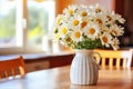 Elegant kitchen table with white daisies - perfect for captivating designs and text placement Royalty Free Stock Photo