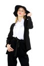 Elegant lady in black suit touching her hat Royalty Free Stock Photo