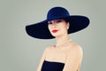 Elegant lady fashion model with red lips makeup, classic hat and white pearls Royalty Free Stock Photo