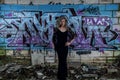 Elegant Lady with Graffiti Wall in Derelict Building