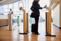 Elegant lady passing electronic turnstile at airport