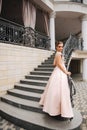 Elegant lady satnd on stairs in front of restaurant Royalty Free Stock Photo