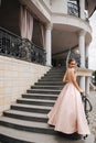 Elegant lady satnd on stairs in front of restaurant Royalty Free Stock Photo
