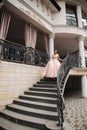 Elegant lady satnd on stairs in front of restaurant Royalty Free Stock Photo