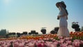 Elegant lady spending time in nature. Romantic woman smiling in flowers garden. Royalty Free Stock Photo