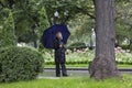 Elegant lady walking in a beautiful park under umbrella Royalty Free Stock Photo