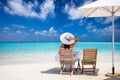 Lady enjoys her breakfast on a tropical paradise beach