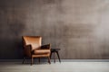 Elegant leather armchair with a stylish side table against a textured dark wall, reflecting a sophisticated interior Royalty Free Stock Photo