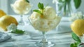 Elegant lemon sorbet in stemware with fresh mint on a reflective surface Royalty Free Stock Photo