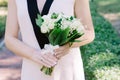 Elegant lily of the valley wedding bouquet in hands of the bride Royalty Free Stock Photo