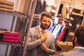 Elegant look. Handsome man in suit adjusting his tie while standing in front of the mirror. Styles, fashionable Royalty Free Stock Photo