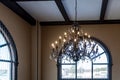 Elegant luster in vintage style hangs on ceiling in hall Royalty Free Stock Photo