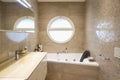 Elegant luxury bathroom with mosaic and circular window