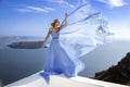 Elegant luxury evening fashion. Glamour, stylish elegant woman in long gown dress is posing outdoor in luxury resort in Santorini Royalty Free Stock Photo