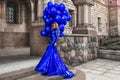 Elegant luxury fashion. Glamour, stylish elegant woman in long gown sequin dress is holding bunch of balloons. Female model in Royalty Free Stock Photo