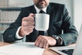 Elegant male business person on coffee break in office