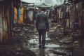 elegant man in an expensive suit walks through a dirty poor slum street Royalty Free Stock Photo