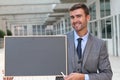 Elegant man holding a board with space for copy Royalty Free Stock Photo