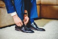 An elegant man puts on black, leather, formal shoes Royalty Free Stock Photo