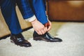 An elegant man puts on black, leather, formal shoes Royalty Free Stock Photo