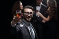 Elegant man raising his glass with the toast