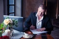 Elegant man signs papers in luxury apartments Royalty Free Stock Photo