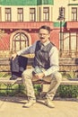 Elegant man sitting on the bench relaxing with a book Royalty Free Stock Photo