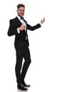 Elegant man in tuxedo presenting and making the ok sign Royalty Free Stock Photo