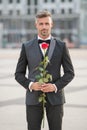 elegant man in tuxedo at romantic occasion. man with romantic present. grizzle romantic man