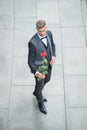 elegant man in tuxedo. man wearing bowtie suit outdoor. grizzle tuxedo man with red rose