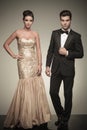 Elegant man and woman posing on grey studio background Royalty Free Stock Photo