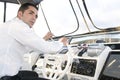 Elegant man at yatch control turnedo