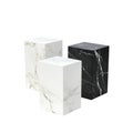 Elegant marble pedestals display, two white and one black, on a clean background Royalty Free Stock Photo