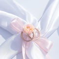 Elegant matrimony Marriage rings with white and pink ribbons backdrop