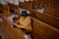 Elegant mature woman praying in church Royalty Free Stock Photo