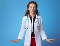 Elegant medical doctor woman calming down on blue