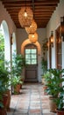 Elegant mediterranean style corridor with arched doorway and lush potted plants Royalty Free Stock Photo