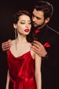 Elegant man in formal wear hugging beautiful girlfriend in red dress Royalty Free Stock Photo