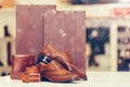 Elegant men leather shoes, belt, wallet, and shopping bags in a background at the shoe store Royalty Free Stock Photo