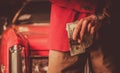 Men with Pile of Cash Money in Front of His Classic Car