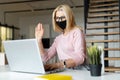 Elegant middle-aged woman greeting in the office during a pandemic Royalty Free Stock Photo