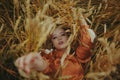 An elegant model lies on a wheat field enjoys nature. The concept of natural products, unity with nature, fashion. Beautiful young Royalty Free Stock Photo