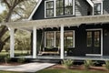 elegant and modern farmhouse exterior with black siding, white trim, and a porch swing