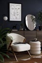 Elegant modern living room interior design with fluffy armchair, pouf, wooden commode, mock up poster frame. Template.