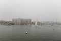 Elegant and modern sailboats moored to a pier in a yacht marina. Thick white fog Royalty Free Stock Photo