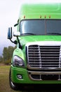 Elegant modern semi truck in green on green parcking lot Royalty Free Stock Photo