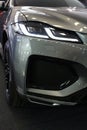 Elegant modern sleek LED headlights and right part of front mask on british luxury crossover SUV car Jaguar F-Pace X761