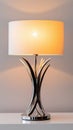 Elegant modern table lamp with chrome base and soft light Royalty Free Stock Photo