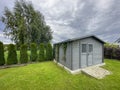 Elegant modern wooden garden shed with lush green lawn Royalty Free Stock Photo